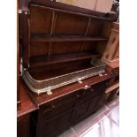 An oak dresser with plate rack back.