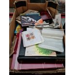 A box of stamps, and album of first day covers, collectors card albums etc