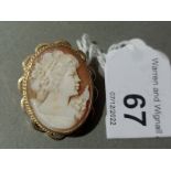 A hallmarked 9ct gold mounted shell cameo brooch.