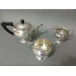 A trio of hallmarked silver tea set comprising of a teapot, twin handled sugar bowl and milk jug,