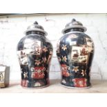 A pair of early 20th century Chinese famille noire lidded vases, height 50cm.