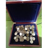 A wooden box of old pennys and 50p's