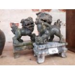 A pair of carved stone dogs of fo.