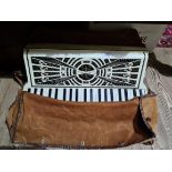 A vintage piano accordion with soft case.