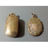 A yellow metal vinaigrette pendant and a yellow metal locket pendant.