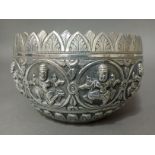 A late 19th century Indian white metal bowl with embossed decoration of a dancing Godess, with