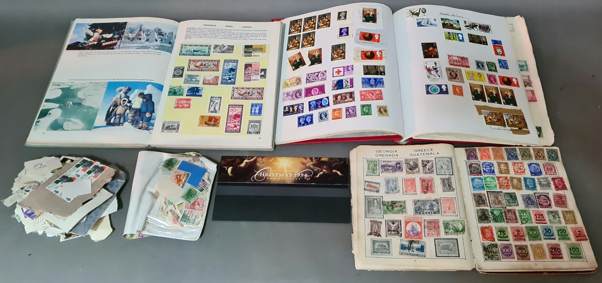 A box containing 3 stamp albums and loose stamps