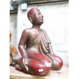 A large gilt and red lacquer Buddha figure, in sitting position, ornated with mirror and coloured