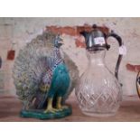 A Chinese porcelain peacock and silver plated cut glass claret jug.
