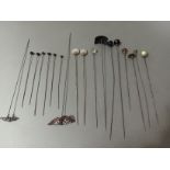 A collection of various antique hat pins to include cut glass, jet, various stones, enamel, etc.