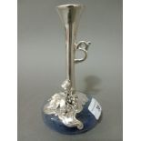 A silver and glass vase depicting grapes and wine leaves in relief, with handle, the glass formed as