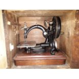 An antique 1871 Willcox & Gibbs hand crank "Automatic" silent sewing machine on mahogany base,