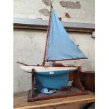 A vintage blue and white painted pond yacht on stand.