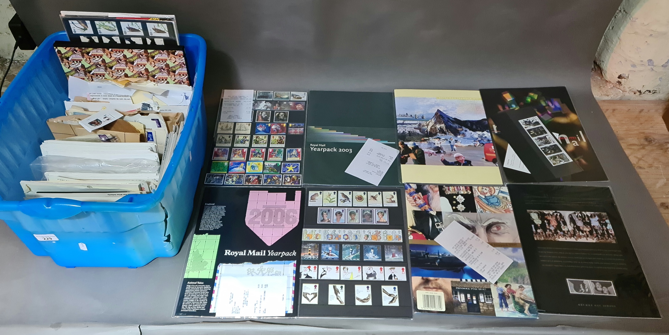 A box of various first day covers, Royal Mail stamp year packs and loose stamps etc.