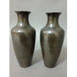 A pair of Chinese bronze Shih So "turnip shaped" vases with a silver encrusted garden scene,