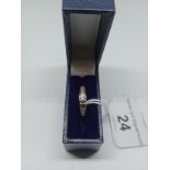 A white metal diamond ring, marked DIA 0.25 ct in associated box.