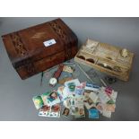A wooden box of collectables including white metal propelling pens, badges to include RAF, silver