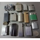 A collection of assorted vintage lighters and a silver pocket watch back marked 800.