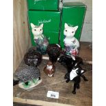 Three Beswick figures - a cat, otters and hedgehog, with boxes, two Old Tupton cat figures and three