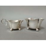A hallmarked silver duo comprised of a sugar bowl and creamer, London, Horace Woodward & Co Ltd,
