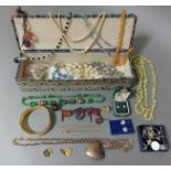 A vintage jewellery box containing costume jewellery including silver.