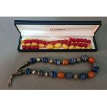 A cherry amber necklace, a yellow satin glass necklace and a white metal, amber and lapis lazuli