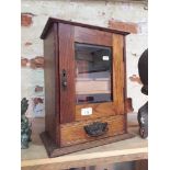 An Edwardian walnut smoker's cabinet.