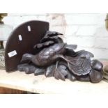 A late 19th century Black Forest carved corner bracket, depicting a grouse on a tree branch, covered