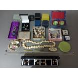 A collection of costume jewellery to include earrings, chains, a musical compact, etc together
