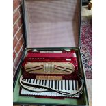 A Hohner Verdi V5 piano accordion with hard case.