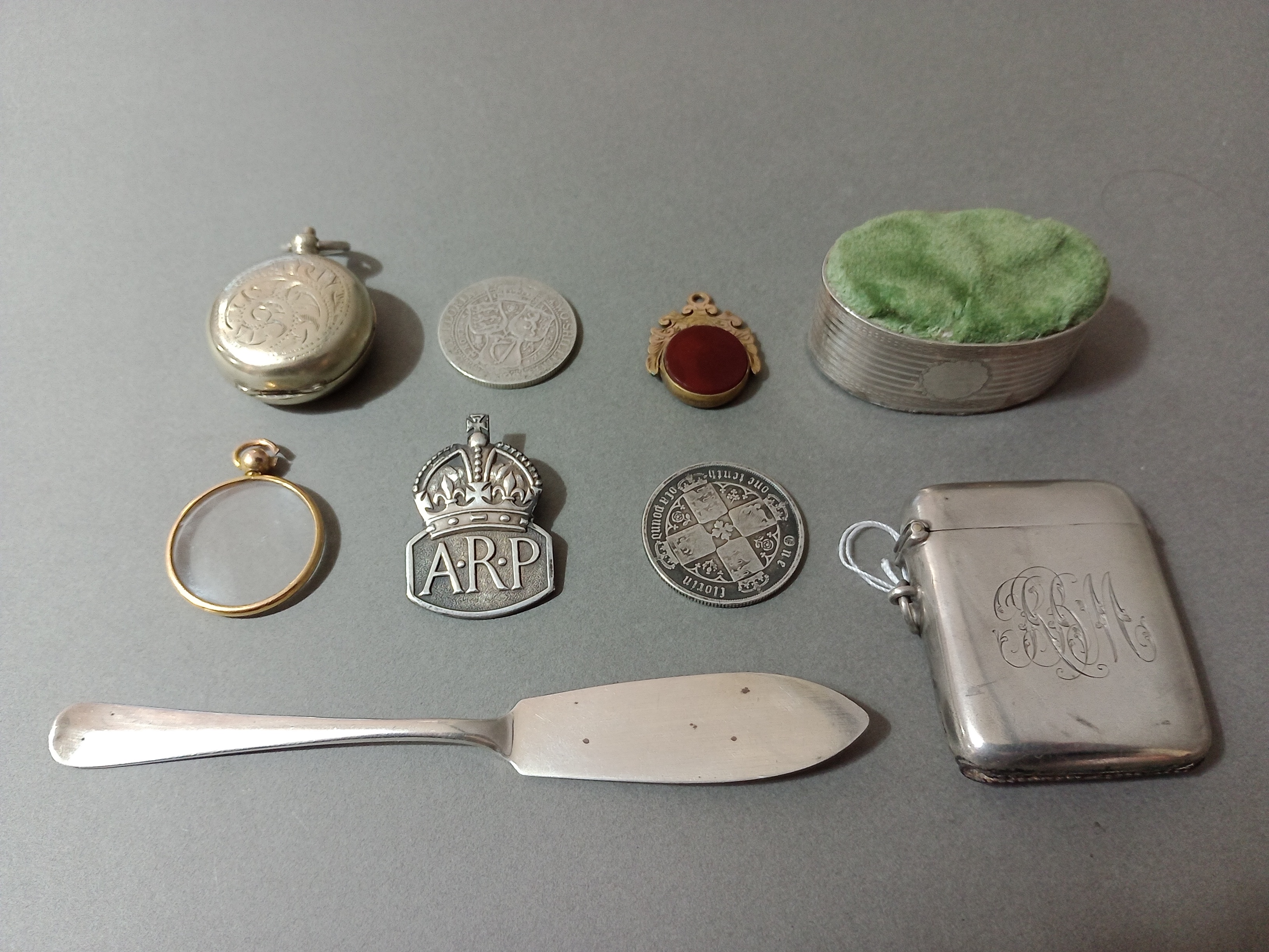 A collection of hallmarked silver items including pin cushion in shape of napkin ring, a vesta case,