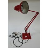 A Herbert Terry & Sons Ltd. red double stepped anglepoise table lamp.