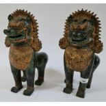 A pair of Chinese cast metal temple dogs, height 31cm.