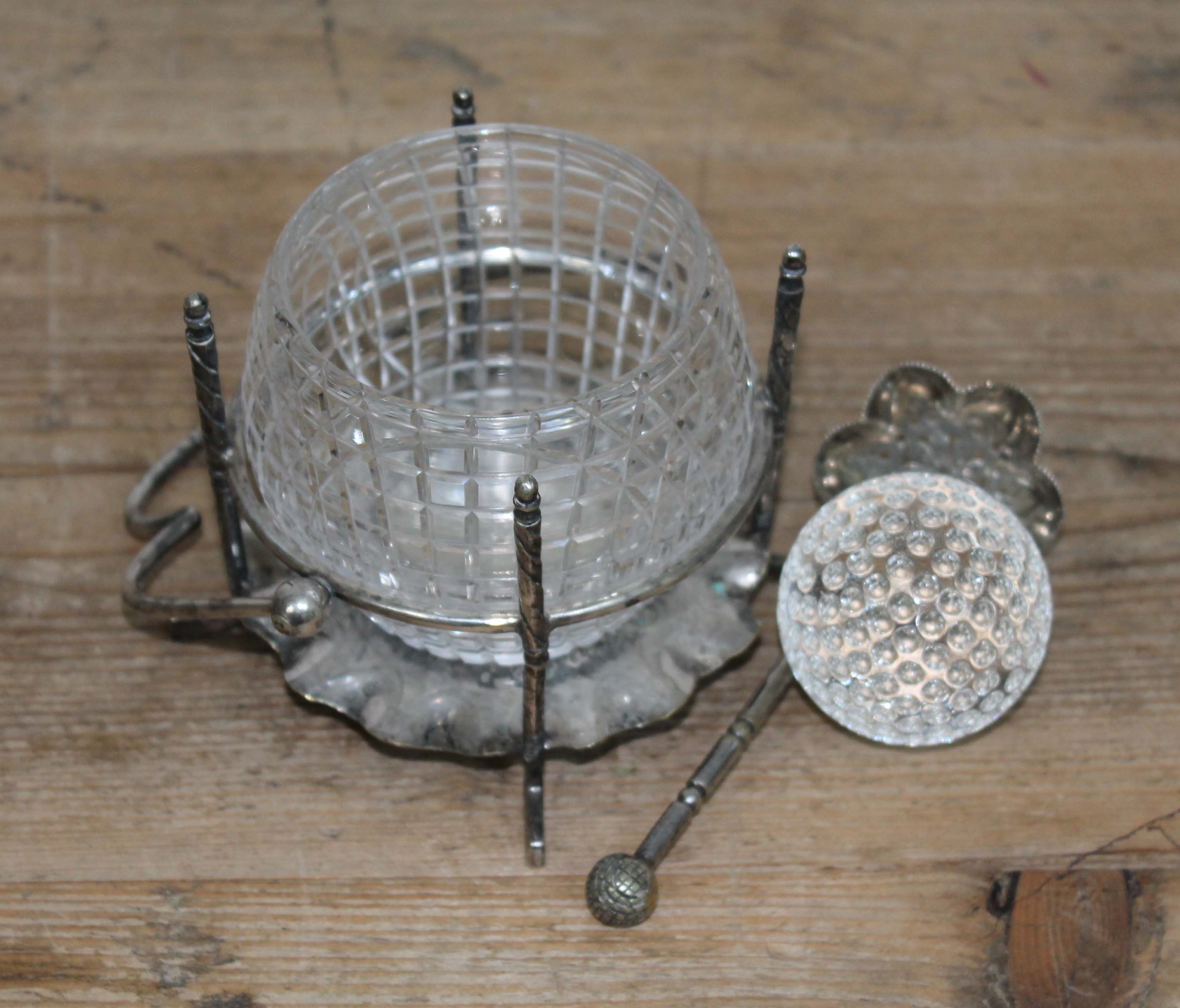 A novelty silver plated sugar bowl, the cut glass bowl modelled as a golf ball held in place with