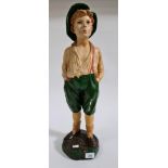 A plaster figure of a whistling boy.