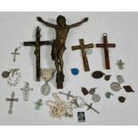 A tin of assorted crucifixes and beads etc.
