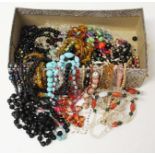 A box of assorted vintage beaded jewellery.