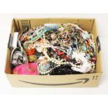 A box of assorted costume jewellery and watches.