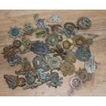 A quantity of assorted cap badges and buttons.