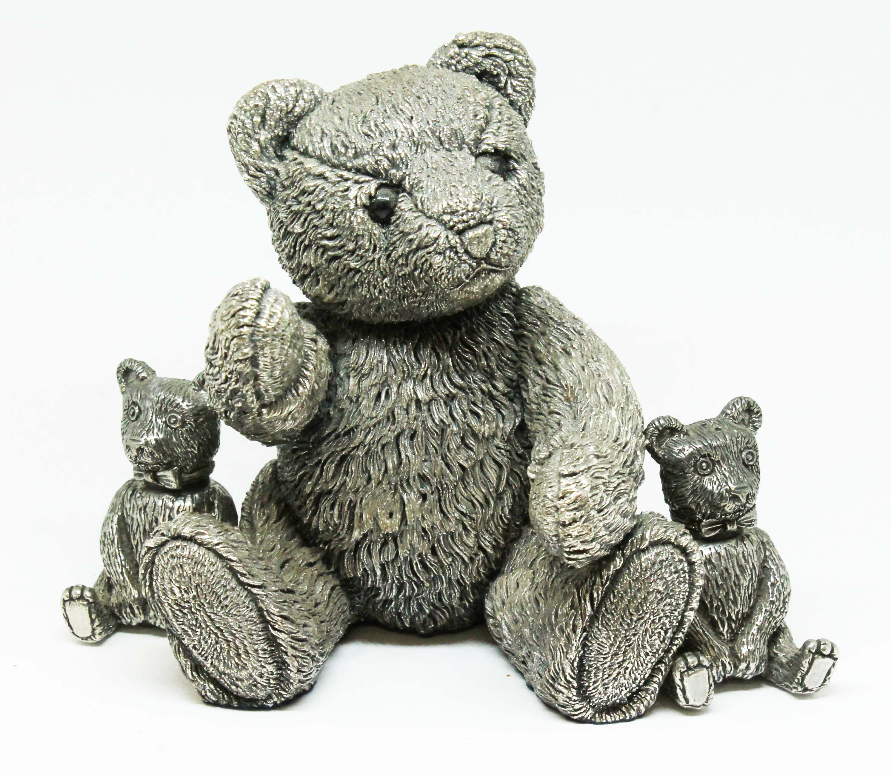 A silver filled bear height 11cm and a pair of silver plated bear salt and pepper pots.