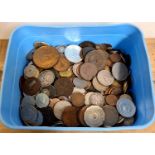 A tub of various world coins including some silver.
