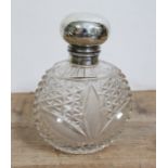 A hallmarked silver topped bottle, height 14cm.