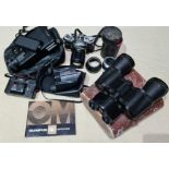 A box of assorted cameras and binoculars.