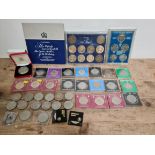 A collection of various commemorative crowns and sets to include a Royal Mint boxed Queen mother