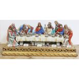 A huge Capodimonte figure "The Last Supper" by Cortese, on wooden plinth, length 85cm.