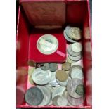 A box containing a collection of UK coins.