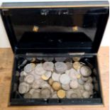 A tin cash box of various GB coins