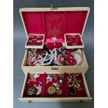 A jewellery box containing vintage and modern costume jewellery to include necklaces, chains,