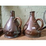 A pair of copper jugs, stamped ER T47.