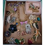 A selection of costume jewellery to include vintage and modern, enamelled, brooches, chains, and a